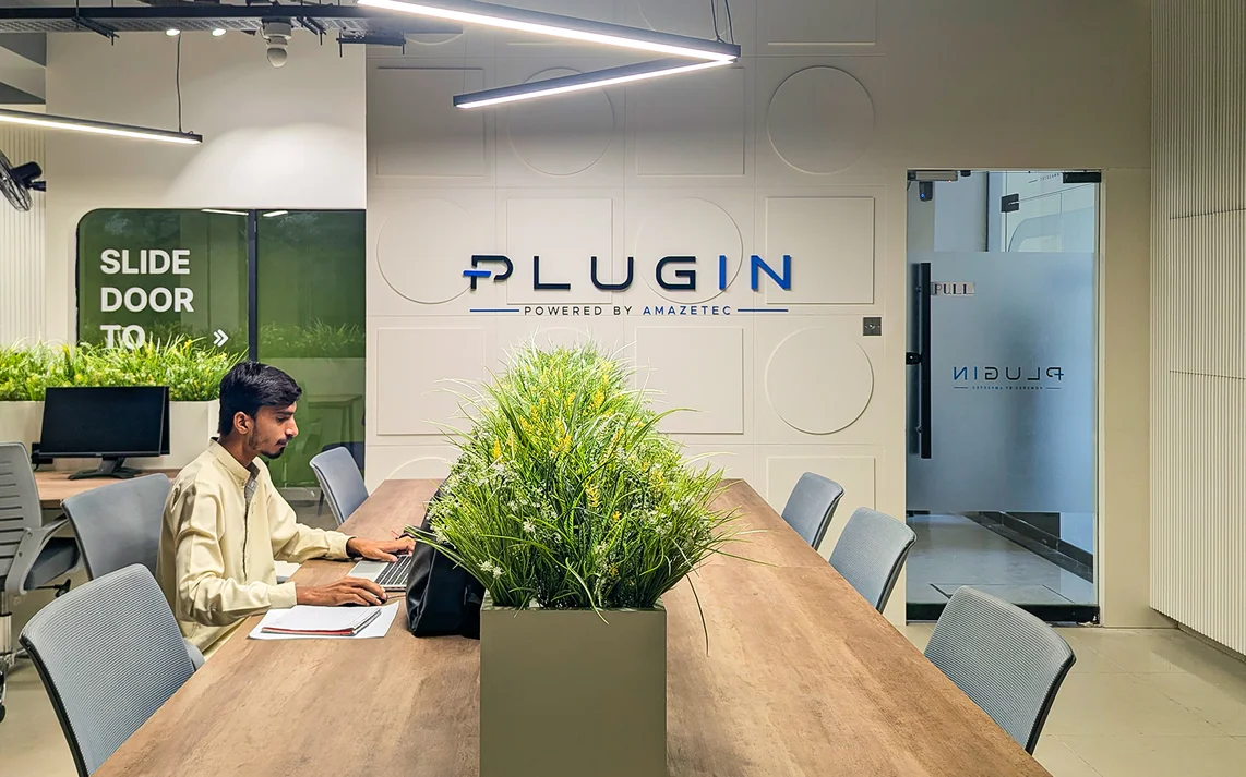 Professional working at Plugin conference table